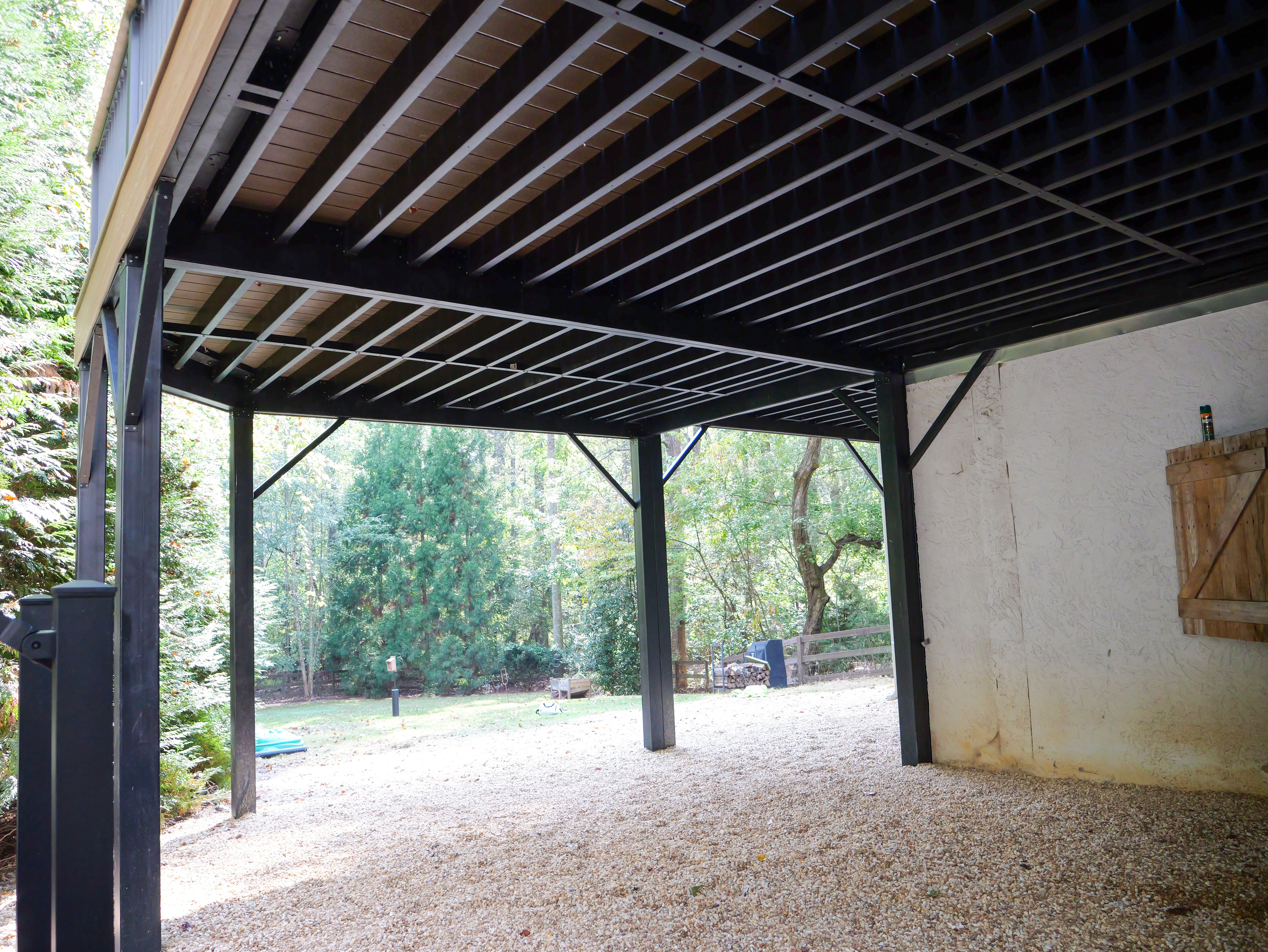 A porch that has been built with pressure treated built in benches by Brawner Renovations for a home in Marietta.